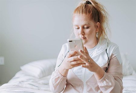 A volunteer checks her text messages